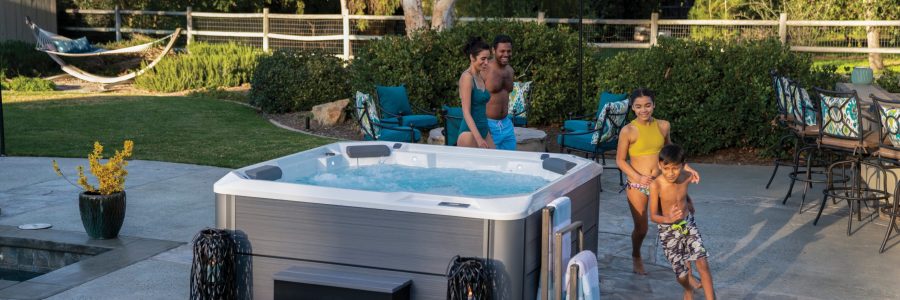 pre owned hot tub header of family running around hot tub